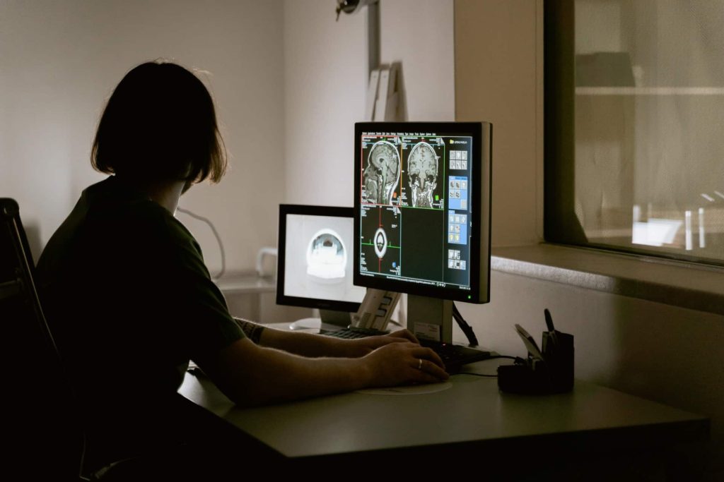 Woman looking at brain scan results on her computer
