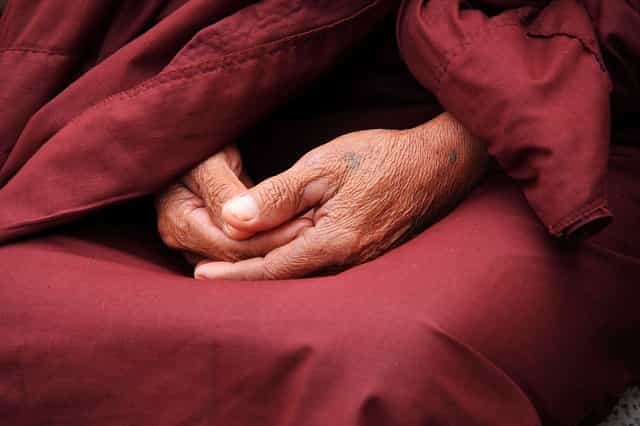 Monk hands in Zen surrendering 