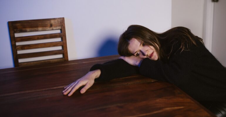 Girl crying on table