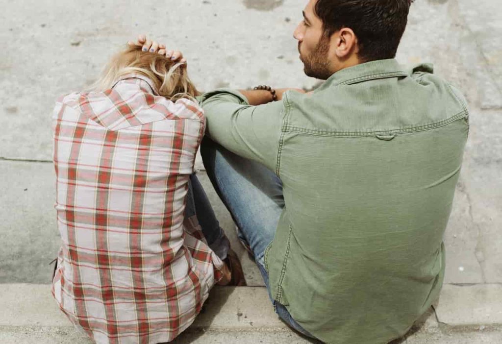 codependent girlfriend sad looking down with narcissist boyfriend.