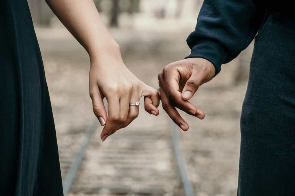 interdependent couple holding hands