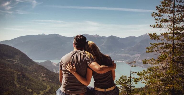 interdependent couple looking at mountain