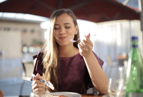 woman enjoying solo dinner outside