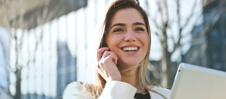 The Basic Requirement For a Fulfilling Career Path girl on phone smiling with her laptop