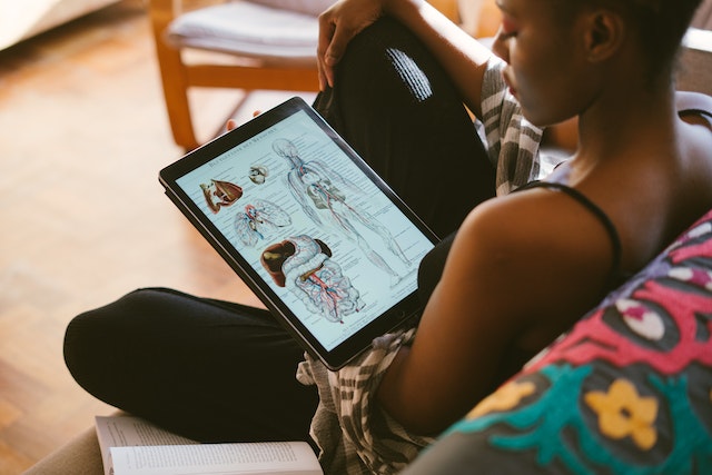 A girl learning about the body's anatomy on her tablet