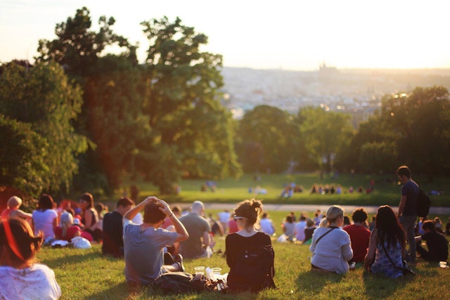 spiritual community sitting in a park on the grass in the sun