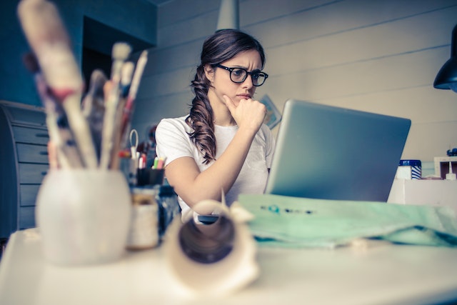 a girl on her laptop thinking on how a narcissist reacts when you stop chasing them