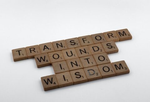 transforming wounds into wisdom spelt out on a scrabble board