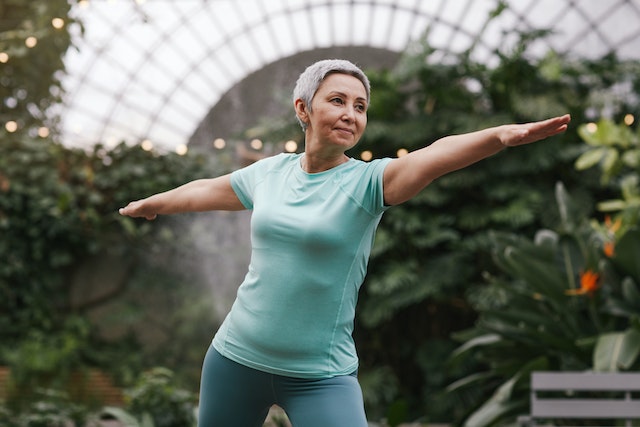 a woman practicing yin yoga in nature as a somatic practice to break trauma bond with a narcissist