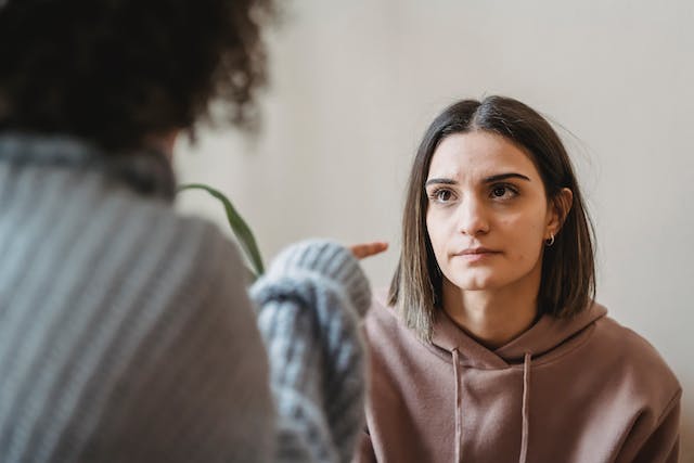 covert narcissist mother pointing fingers at her adult daughter making her feel ashamed